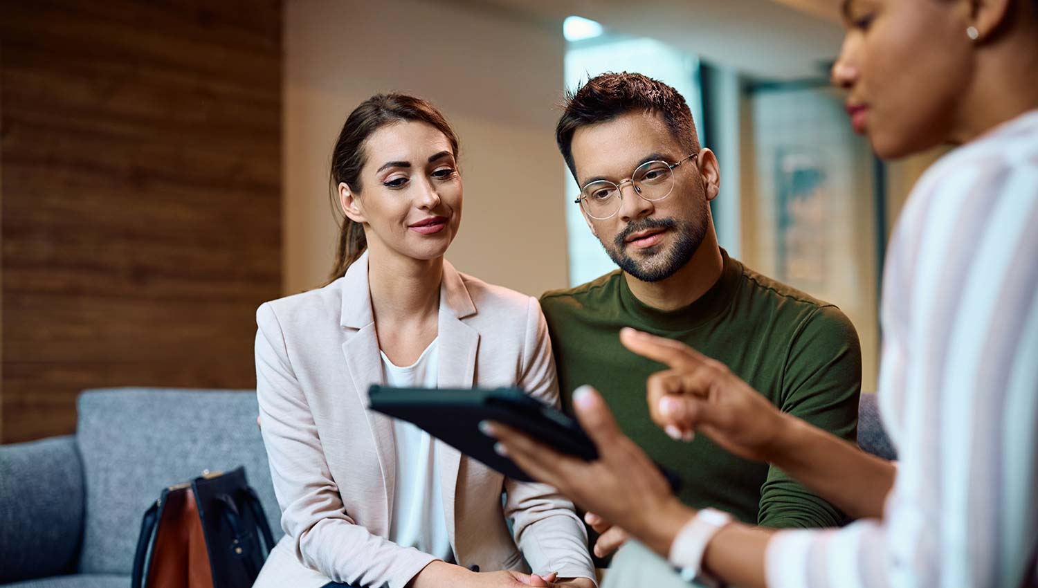 Couple reviewing loan with bank official